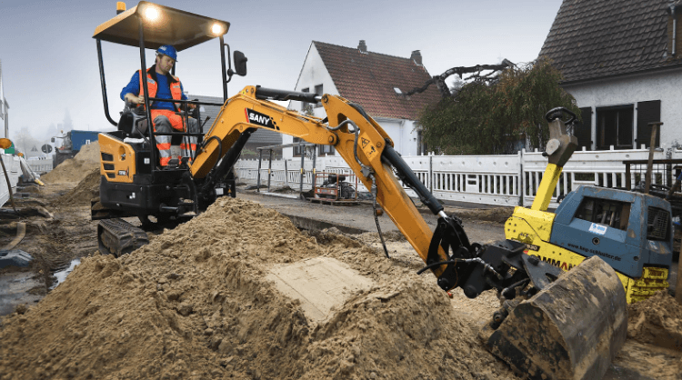 Man operating a mini excavator