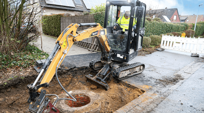 mini-excavator digging around a well