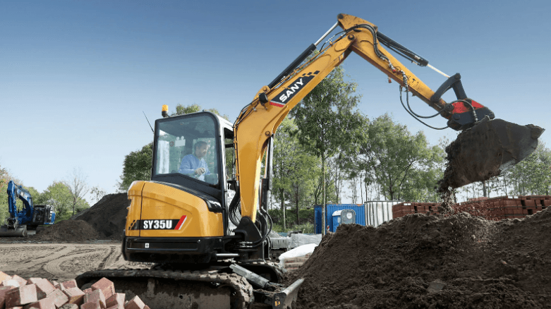 Excavator is dumping soil onto a pile